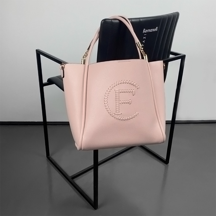 pink bag on the black chair 